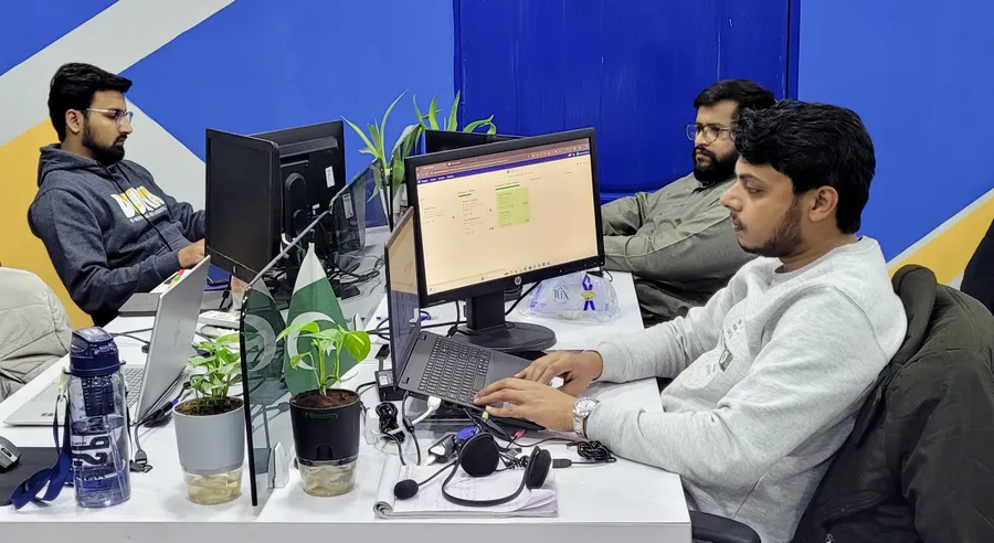 Colleagues working together at their desks at the Visiomate office