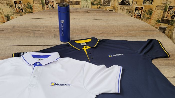 A navy Visiomate polo shirt and a branded bottle